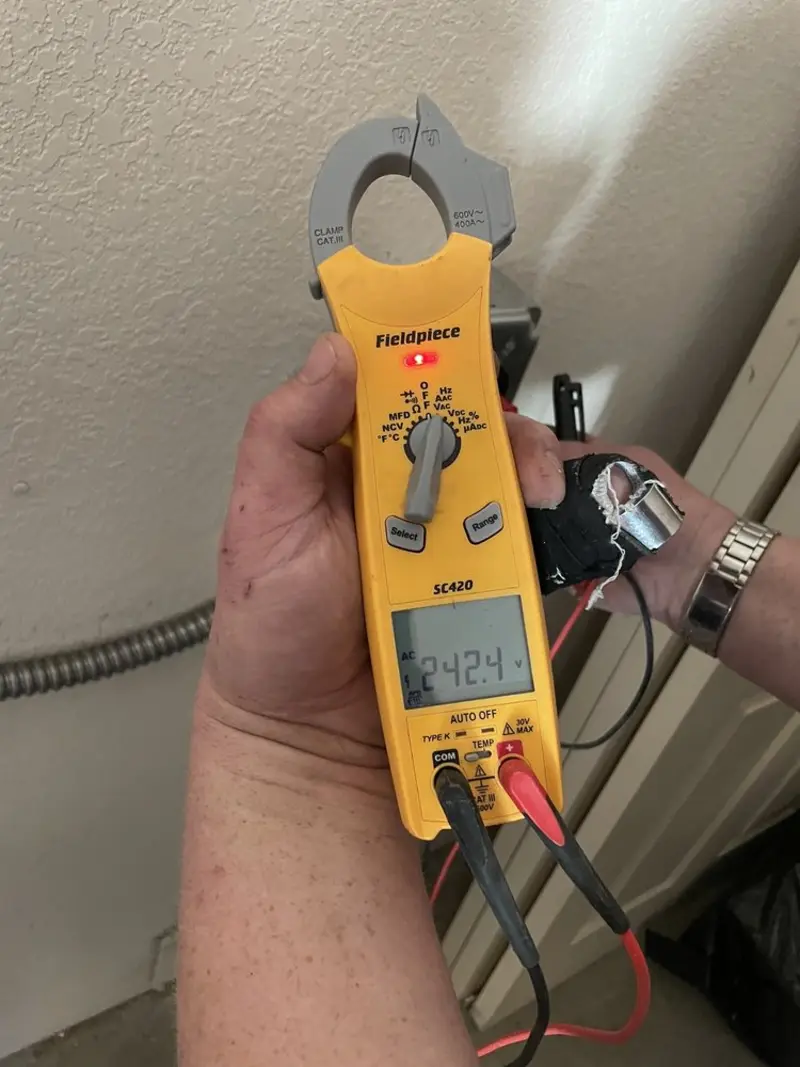 Voltage testing with clamp meter during Recessed Lighting Installation in Homewood